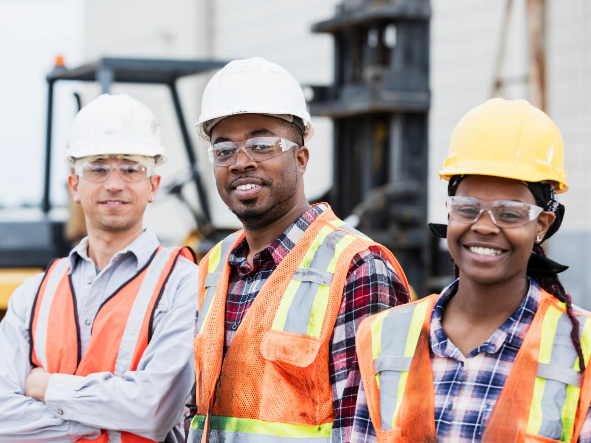 construction workers, standing around construction site smiling, crane  operatros